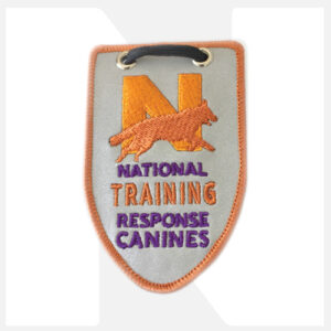Embroidered patch for National Training Response Canines with a paw print and large 'N'.