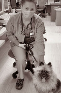 Nurse petting crisis canine during Covid-19 outbreak.